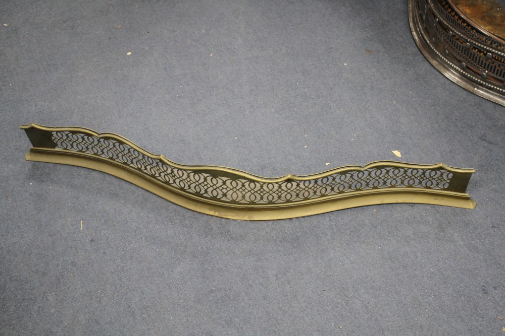 A George III cut steel fender, W.116cm, two other fenders and four assorted brass jardinieres